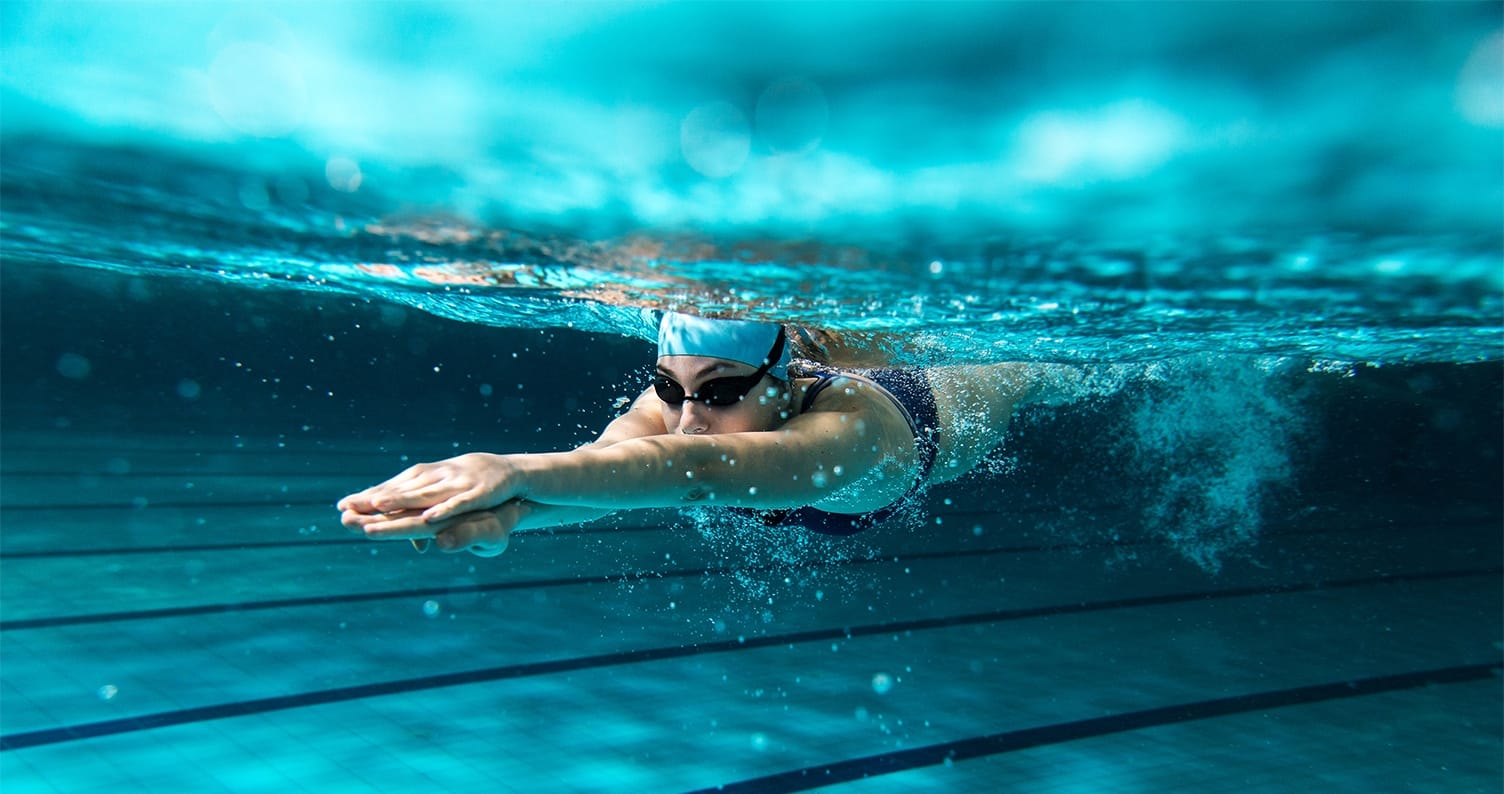 women swimming under water