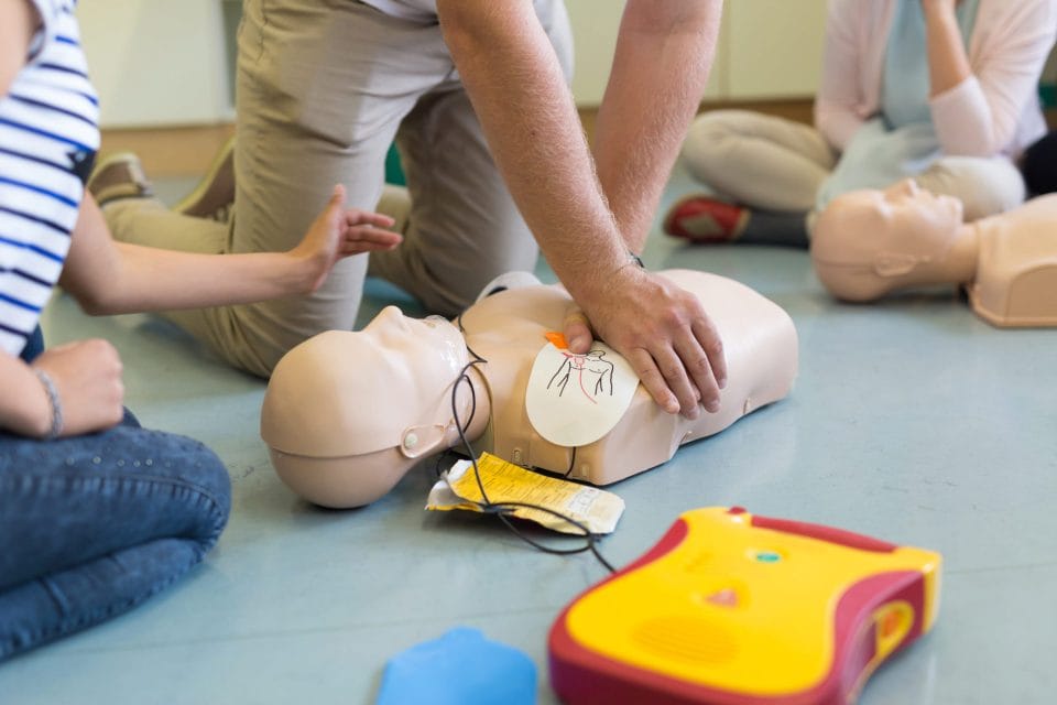 people training on an AED