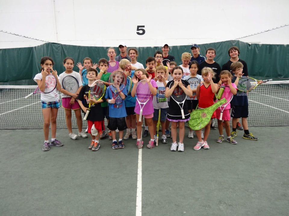 kids making funny faces in group tennis class photo