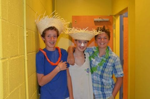 counselors in training dressed up with Hawaiian leis and straw hats during a day at camp greenwood