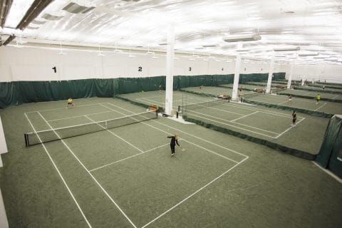 people playing on club greenwood indoor tennis courts