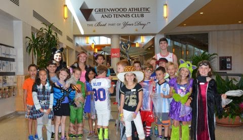 kids dressed up in costumes with their camp counselors at camp greenwood in the club greenwood lobby