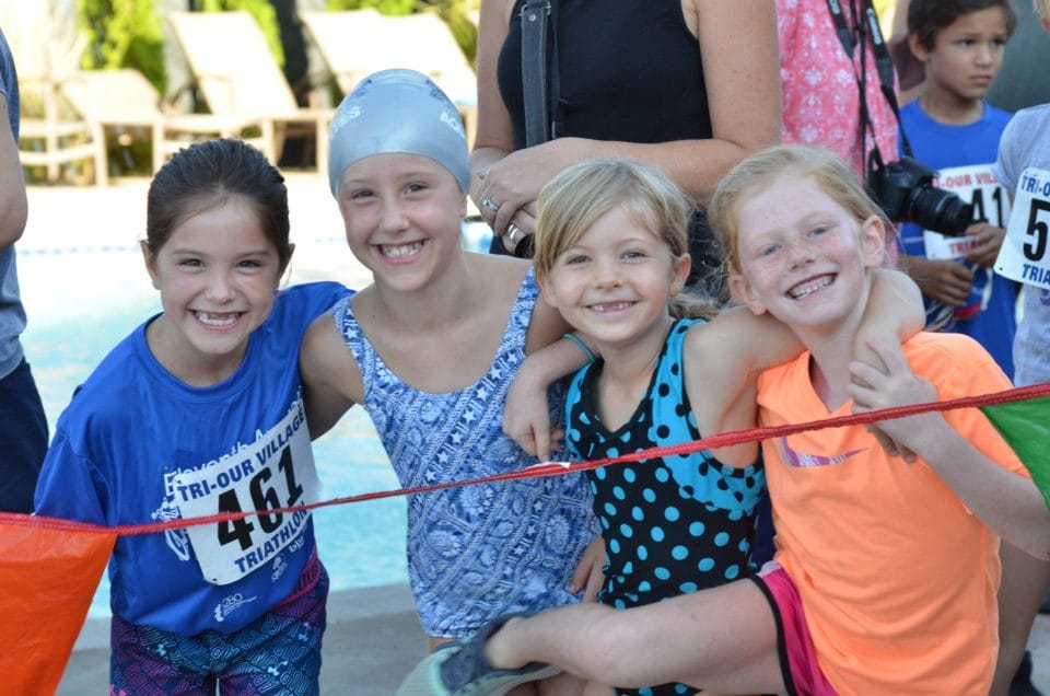 girls smiling before greenwood village kids triathlon