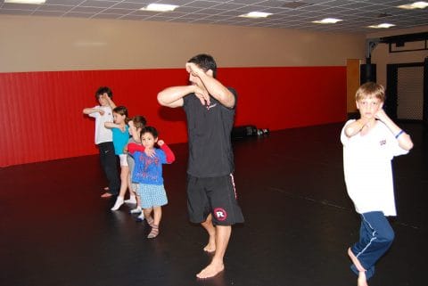 master personal trainer vic spatola teaching kids martial art in combat zone