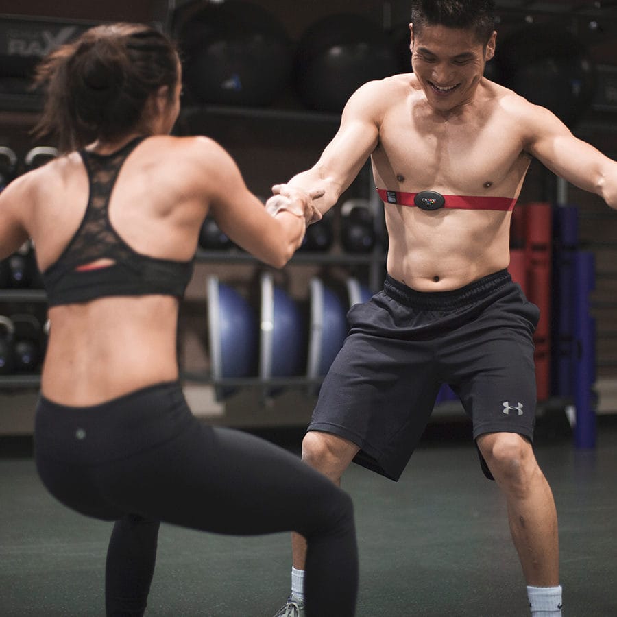 man and woman working out together with myzone belts