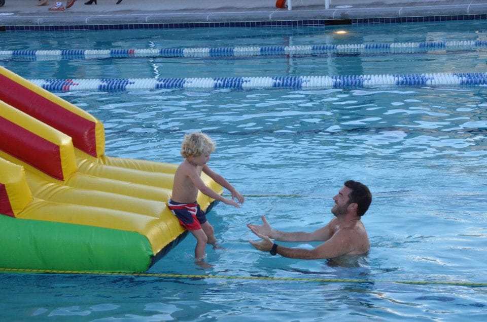 parent with kid in club greenwood outdoor pool