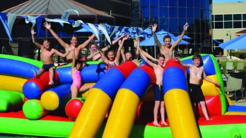 kids playing on summer pool float on club greenwood outdoor pool
