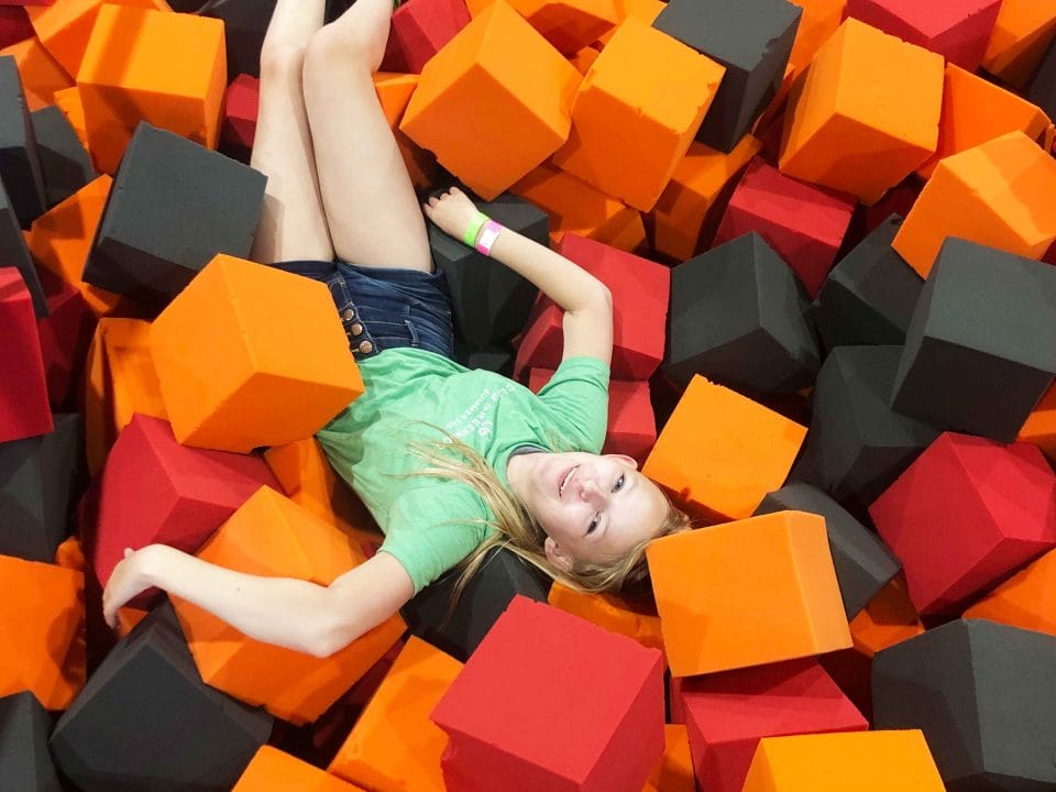 girl playing in foam pit