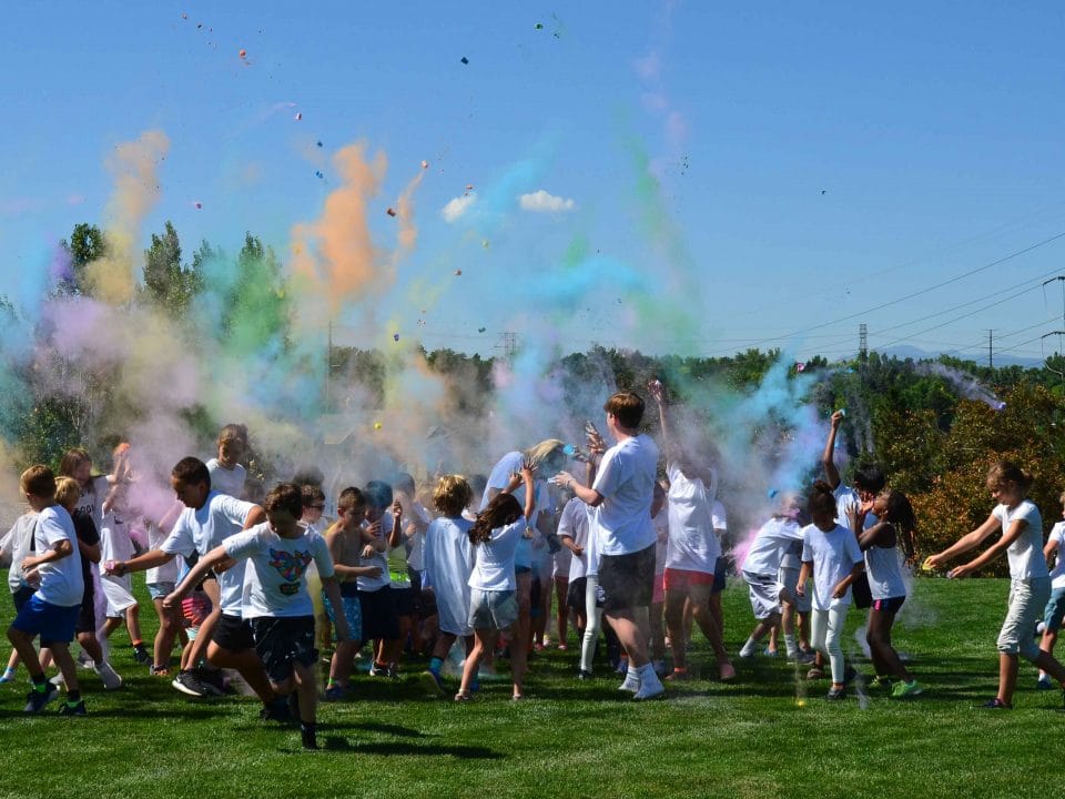 kids playing outside in color run