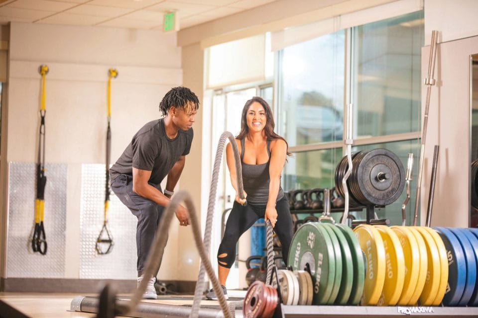 personal trainer brandon smith training woman on battle ropes in club greenwood weightroom