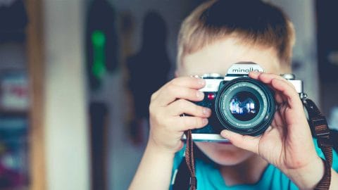 small boy taking pictures with a camera