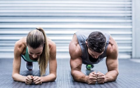 man and woman doing a fore arm plank