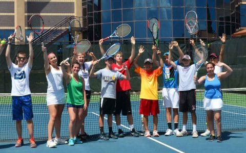 teens having fun with tennis on an outdoor court