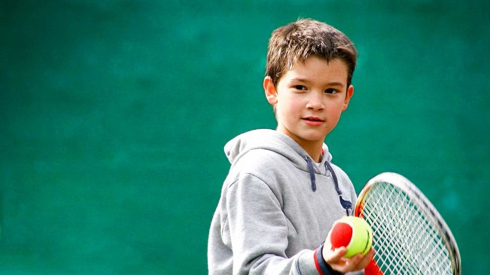 kid playing tennis