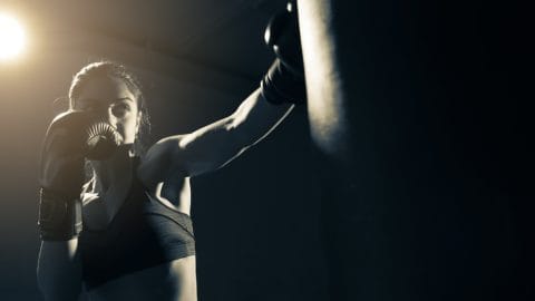 woman boxing in dark room