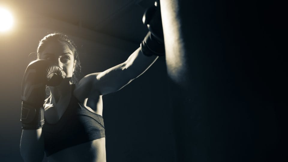 woman boxing in dark room