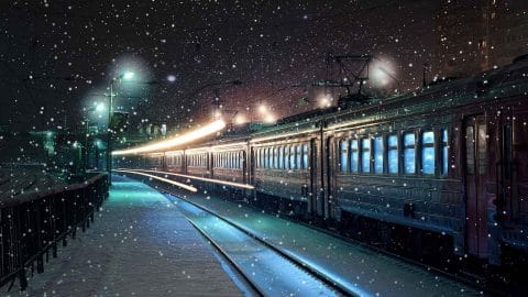 train driving through snow at night