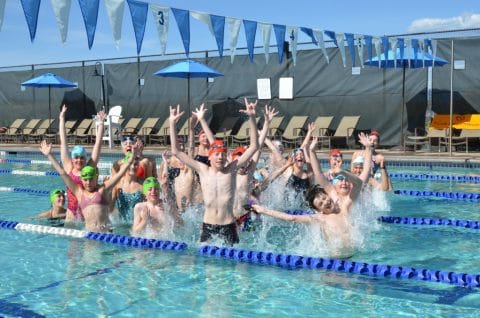 Greenwood tiger sharks swim team in outdoor pool