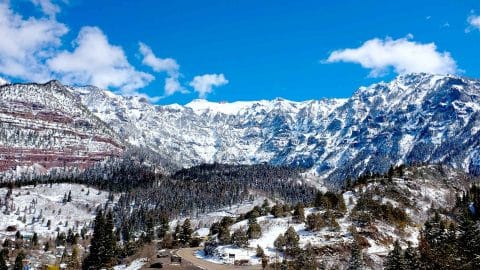 beautiful rocky mountains covered in snow with blue sky