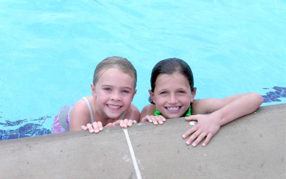 girls smiling in a pool