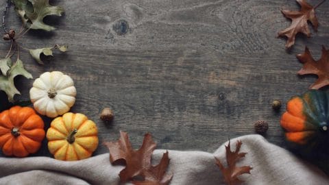holiday background with pumpkins and leaves