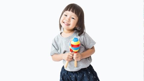 Cute little girl playing maracas