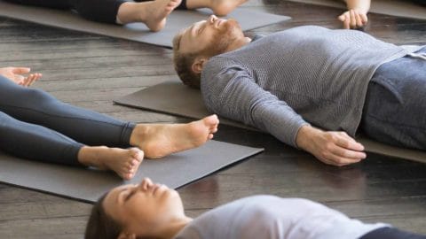 people laying down and doing yoga