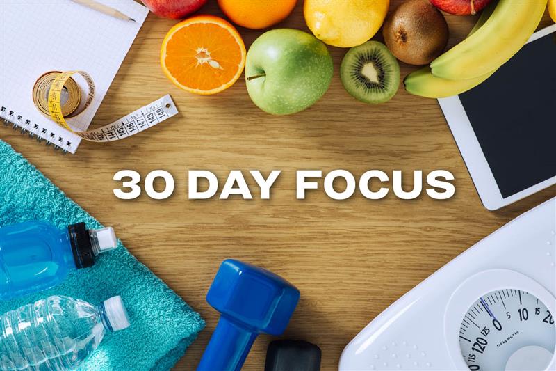 30 Day Focus text next to fruits, water bottles, a scale, and notebook