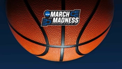 basketball in front of a navy blue background with a graphic that says march madness