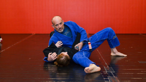Brazilian Jiu-Jitsu Instructor and Student on mat