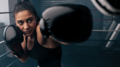 woman boxing at an indoor boxing ring