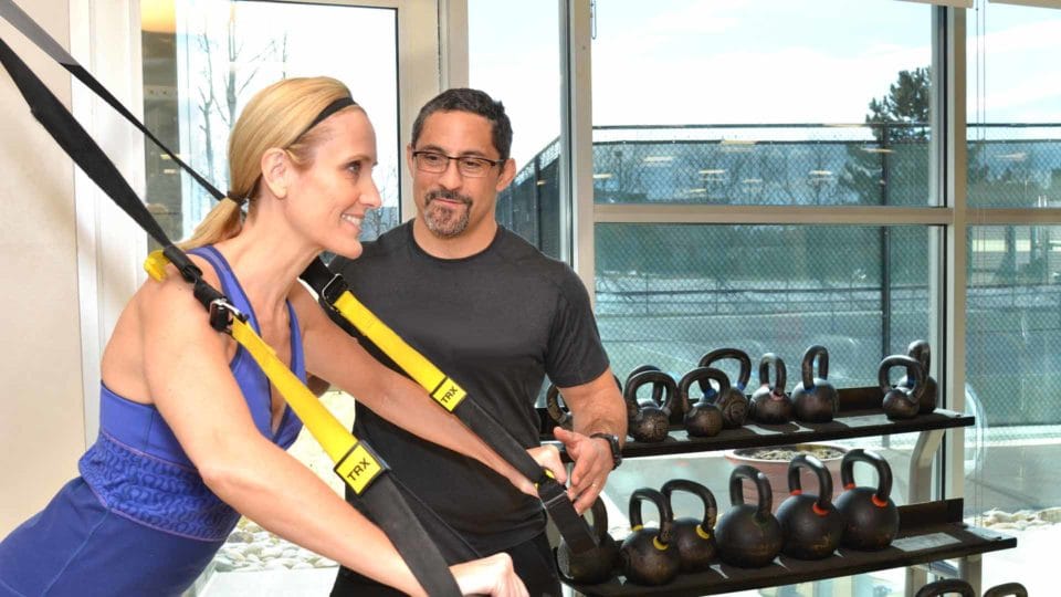 club greenwood master trainer vic spatola training a club greenwood member on TRX