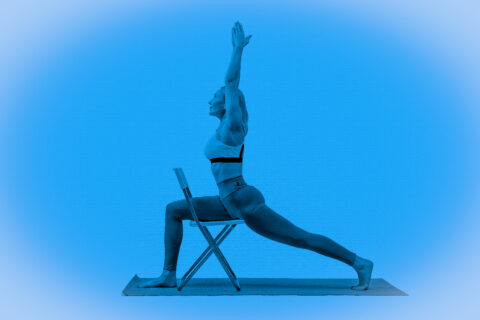 woman doing yoga with a chair