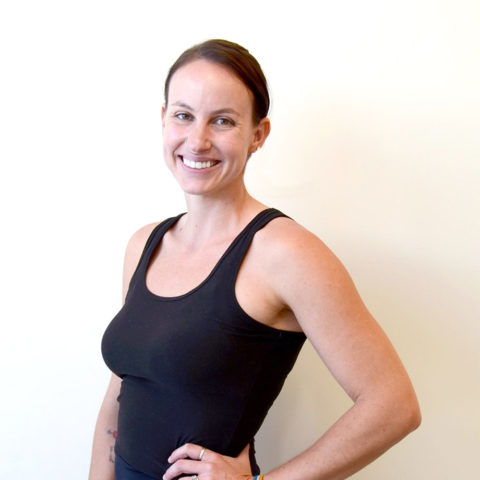 club greenwood yoga sculpt instructor emma long smiling wearing a black shirt