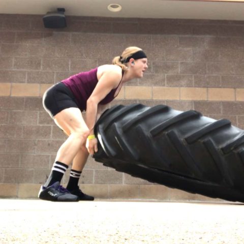 Club Greenwood personal trainer Kim Galbreath working out and flipping tire