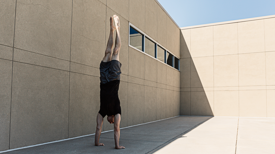 man performing handstand outside