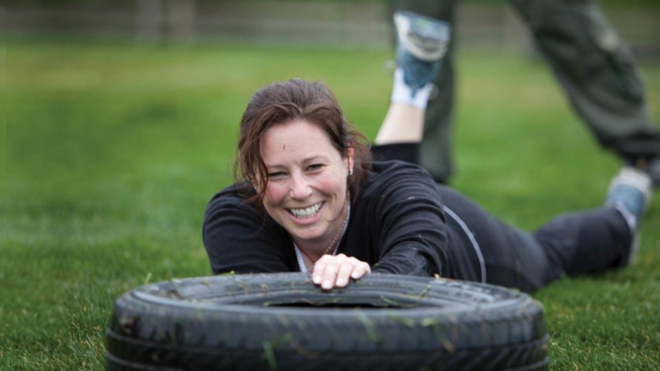 woman with a tire workout out outside