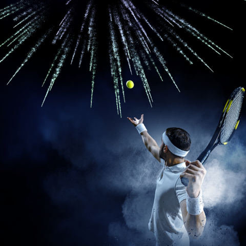 man playing tennis in a studio with fireworks