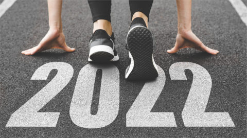 Woman running on road that says 2022