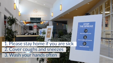 club greenwood lobby with signs for protecting against covid