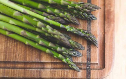 asparagus on a wood cutting board