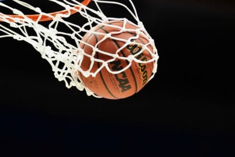 basketball falling through a basketball hoop and net