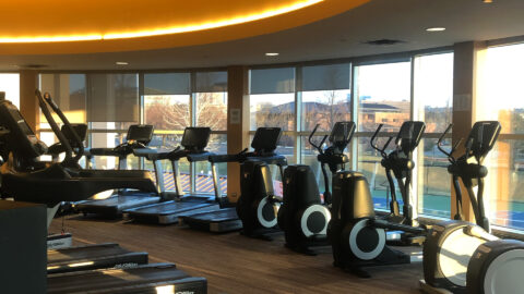 upper cardio area at club greenwood with ellipticals, rowing machines and treadmills