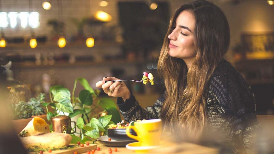 woman eating healthy food and smiling