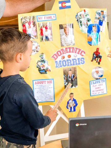 kid standing in front of a project about him and his family