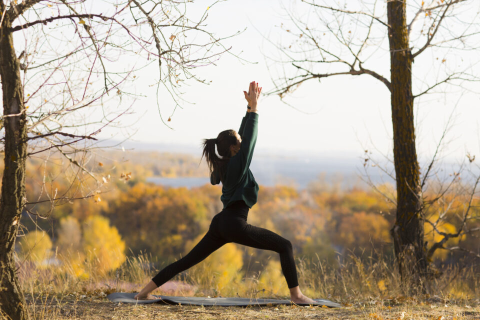 woman practicing yoga on the mountain in autumn. solo outdoor activities. Social Distancing woman practicing yoga on the mountain in autumn. solo outdoor activities. Social Distancing