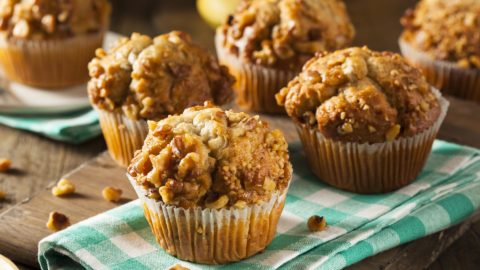 healthy muffins with nuts sitting on a green plaid napkin on a table